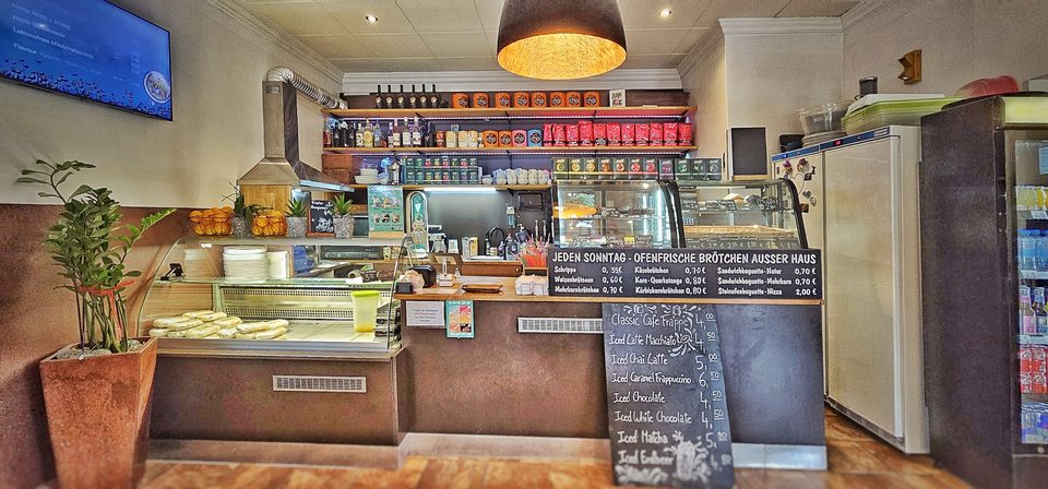 Die Theke der Kaffee Station mit Kuchenvitrine und Kreidetafel-Menü